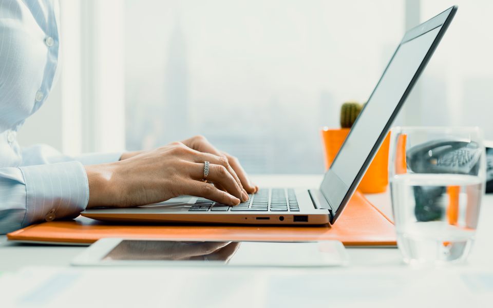 A manager placing an order on a laptop